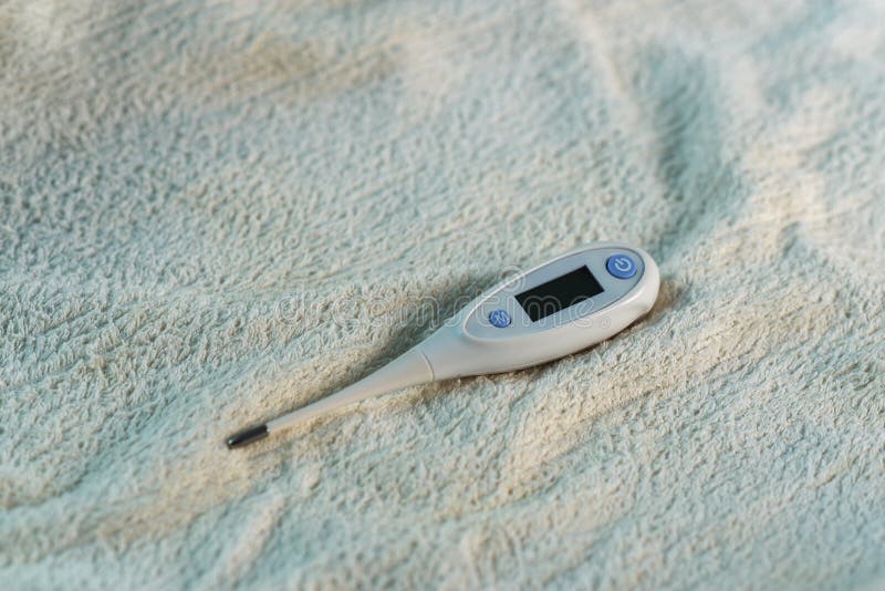 White Electronic Thermometer Lying on Blanket Stock Image Image of
