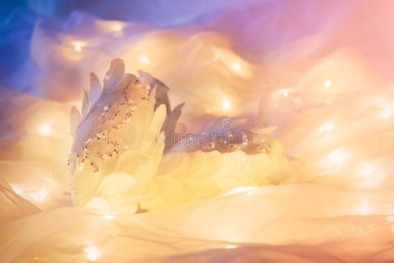 White feathered Christmas ornaments with some Xmas lights stock images White feathered Christmas ornaments with some Xmas lights stock images