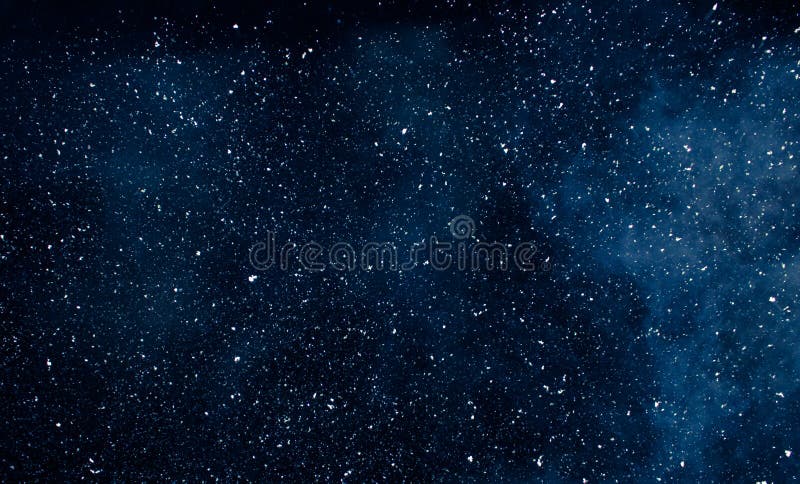 White flakes of snow on a dark blue background royalty free stock images