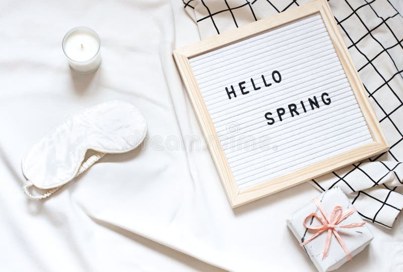 White Flat Lay on the Bed Blanket with Text `Hello Spring`. Stock Image