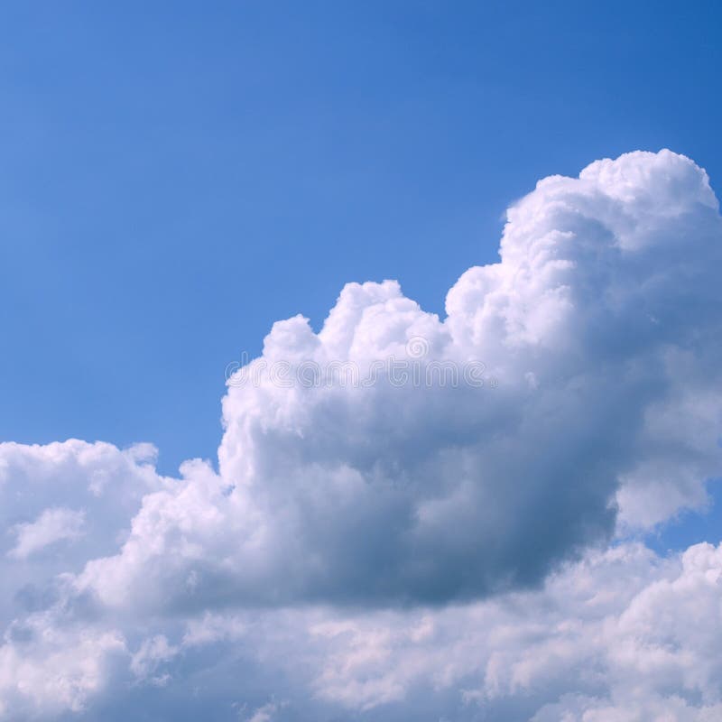 White fluffy clouds in the vast blue sky. Abstract nature background. For instagram format. Square. Space for text.