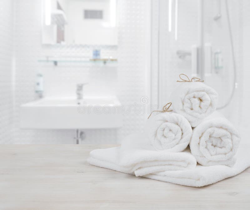 White folded spa towels on defocused interior background of bathroom royalty free stock photos White folded spa towels on defocused interior background of bathroom royalty free stock photos