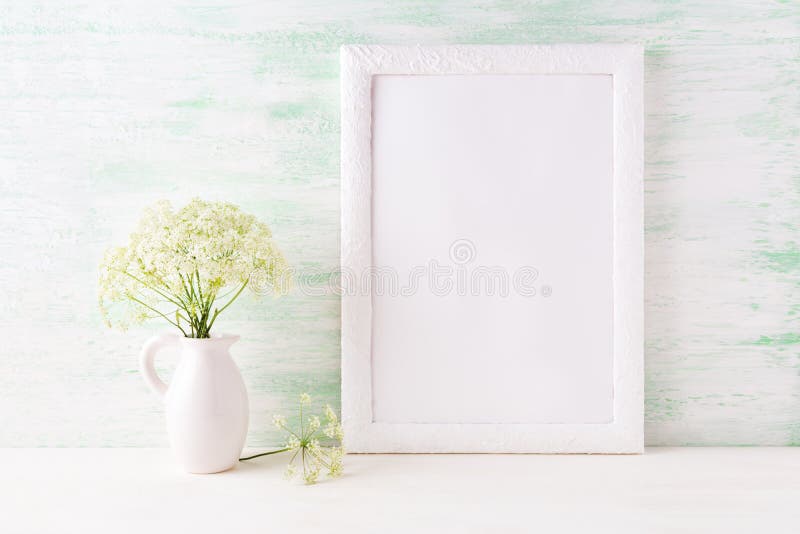 White frame mockup with delicate wild field flowers in pitcher