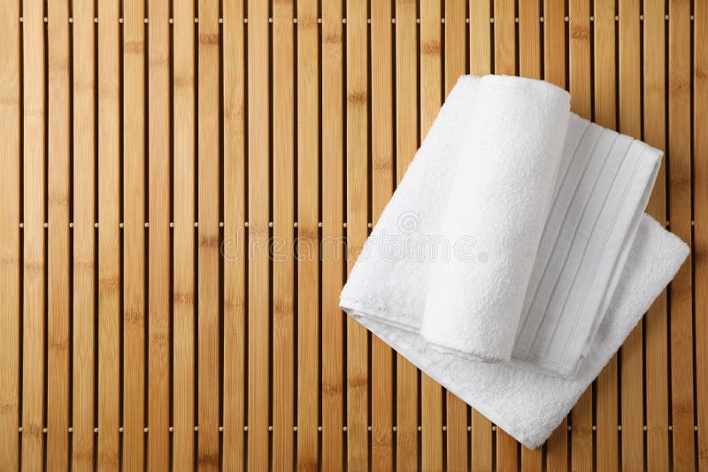 White fresh towels on bamboo background