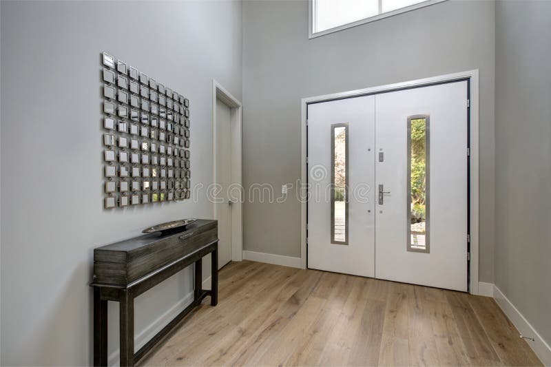White front door opens to a contemporary foyer