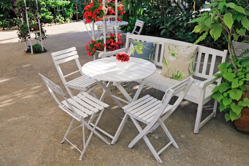 White furniture in a beautiful garden. royalty free stock photos