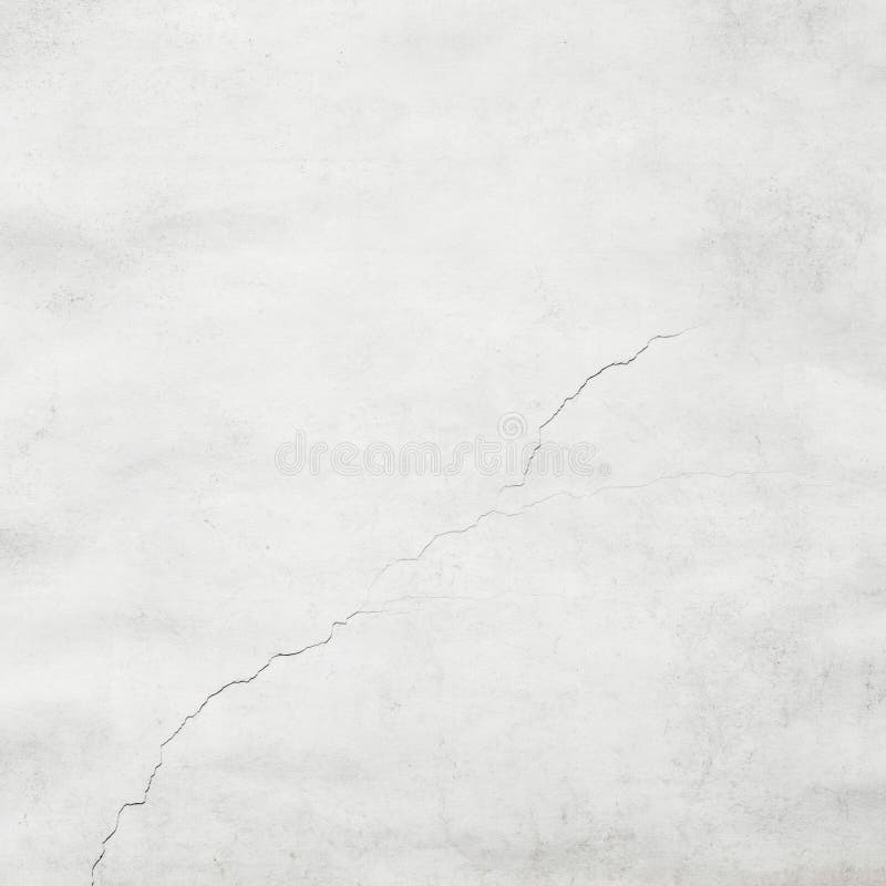 White grungy cracked stucco wall texture background. White grungy cracked stucco wall texture background.
