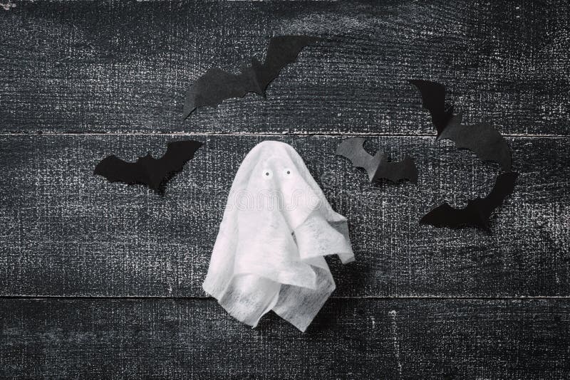 White Ghost Costume on Dark Black Wooden Background. Minimalistic ...