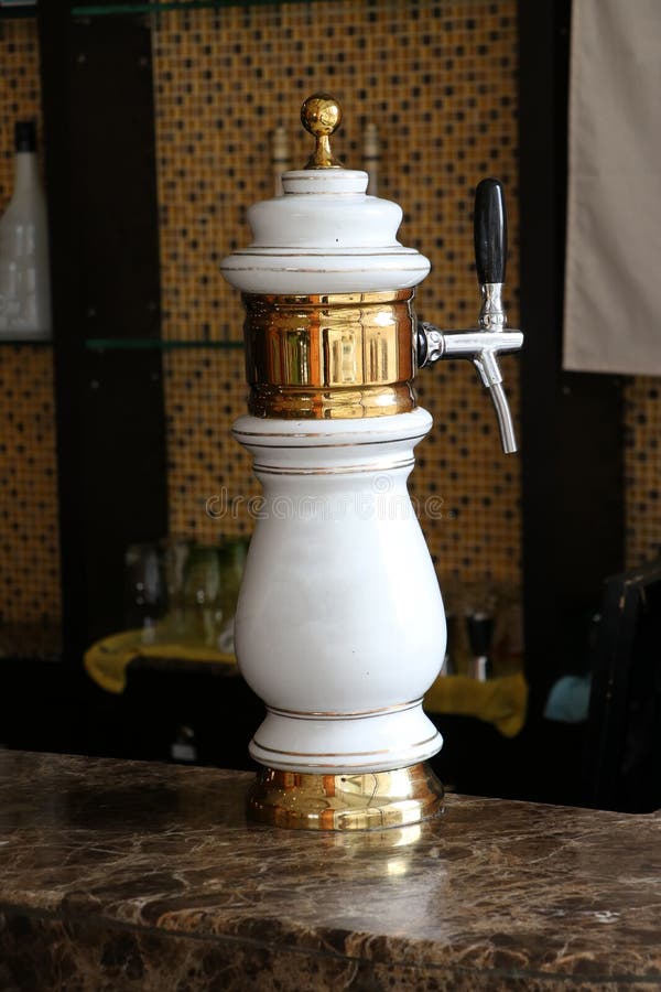 White and gold beer tap with classic design at a marble bar or counter bar