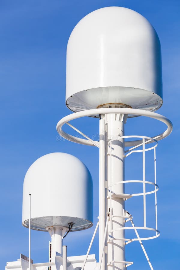 White GPS tracking antennas mounted on mast