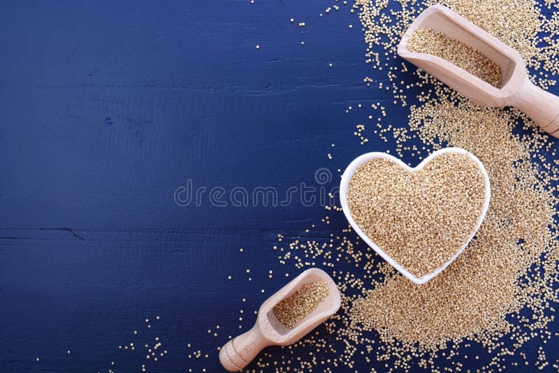 White grain quinoa on blue wood background.