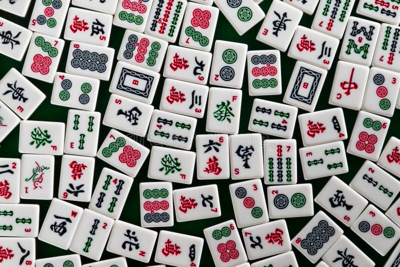 White-green tiles for mahjong on on green cloth background