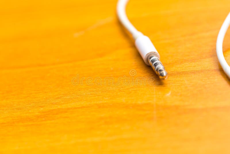 White headphones lying on wooden table royalty free stock images