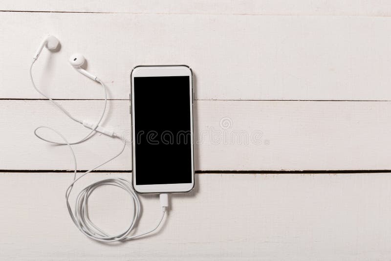 Headphones with Smartphone on wooden background