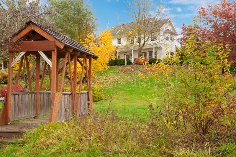 White horse farm American house during fall with green grass. stock images White horse farm American house during fall with green grass. stock images