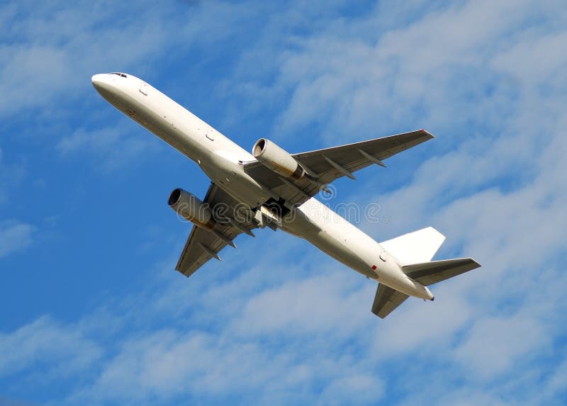 White jet airplane flying overhead