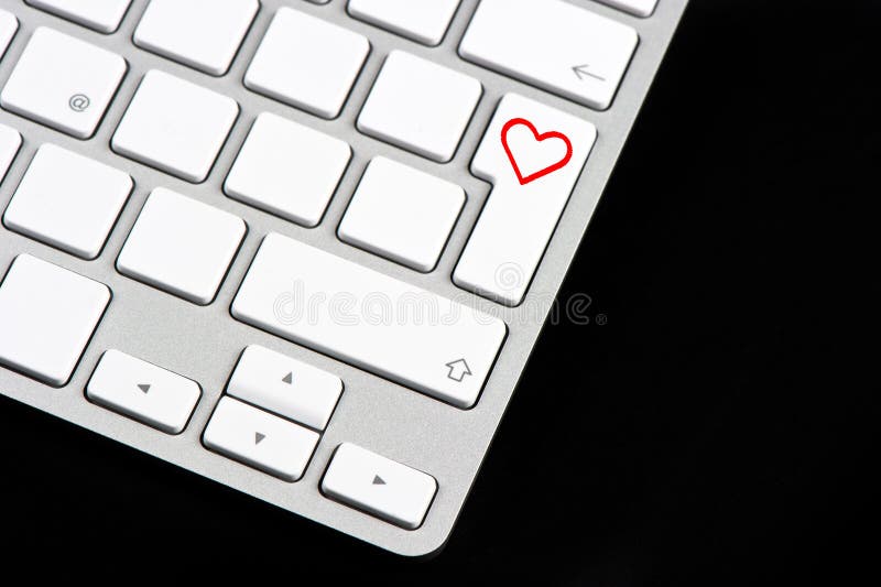 White keyboard with red heart button on black background
