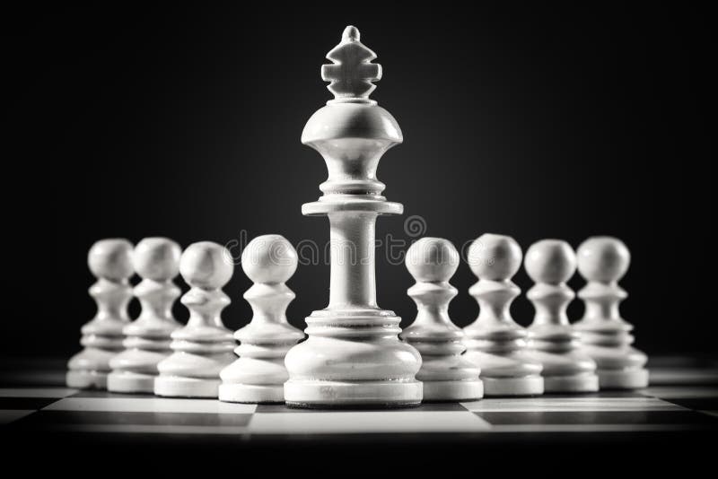White king chess standing in front of the pawn chess stock image