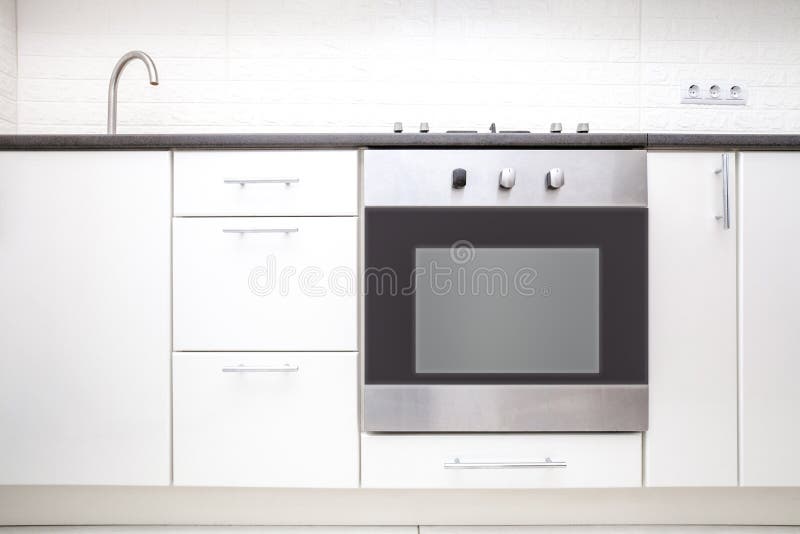 White kitchen cabinet and oven front view