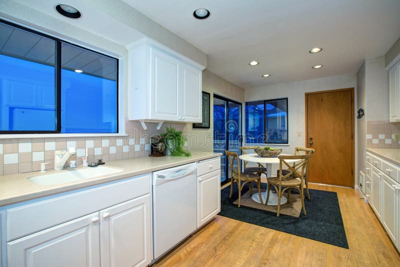 White kitchen design with hardwood floor and white appliances