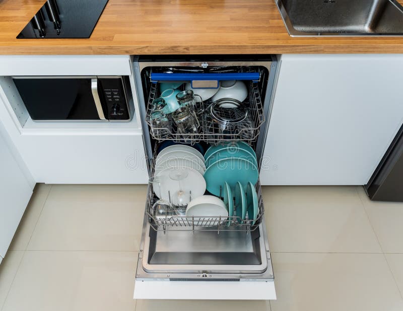 The White Kitchen and Opened Dishwasher with Clean Dishes Stock Photo