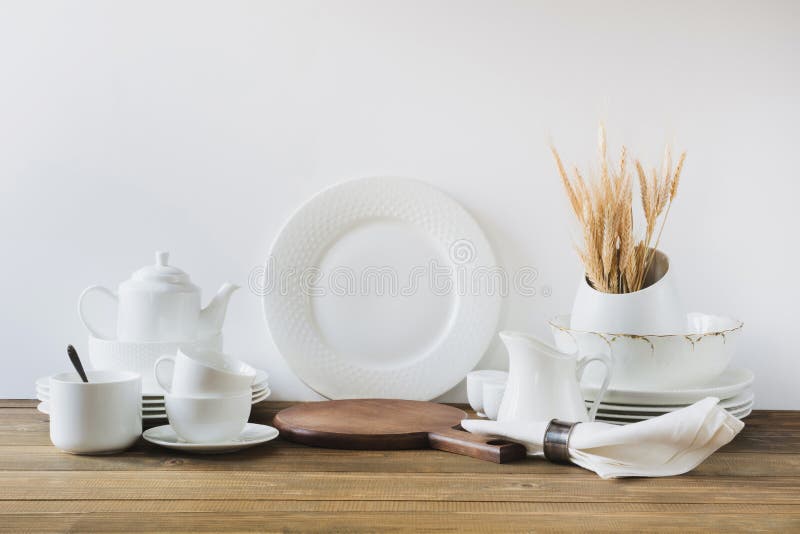White kitchen utensils, dishware and other different white stuff for serving on white wooden board. royalty free stock photos White kitchen utensils, dishware and other different white stuff for serving on white wooden board. royalty free stock photos