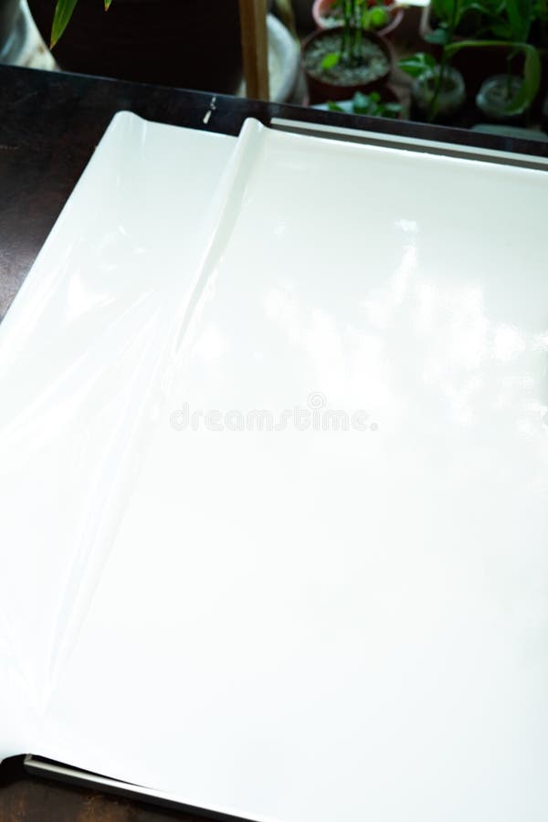 White Laminated Sticker on the Furniture. Installing Sticker at Home