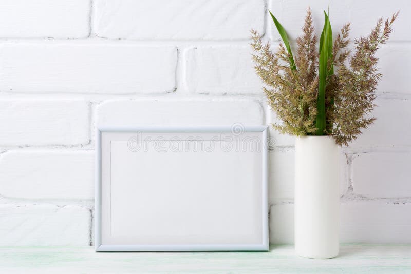 White landscape frame mockup with grass and green leaves in cyl