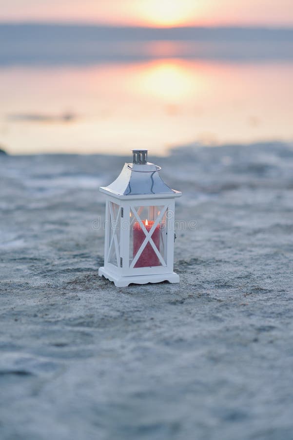 White lantern on the shore of a salty estuary