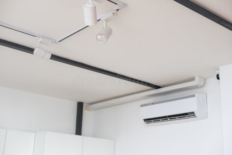 White led spotlight standing in white background. the system runs suspended from the ceiling on the rail. The head of royalty free stock images