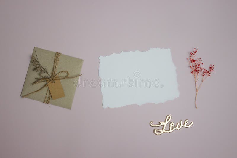 White letter, brown envelop and red flowers over the pink background. stock image