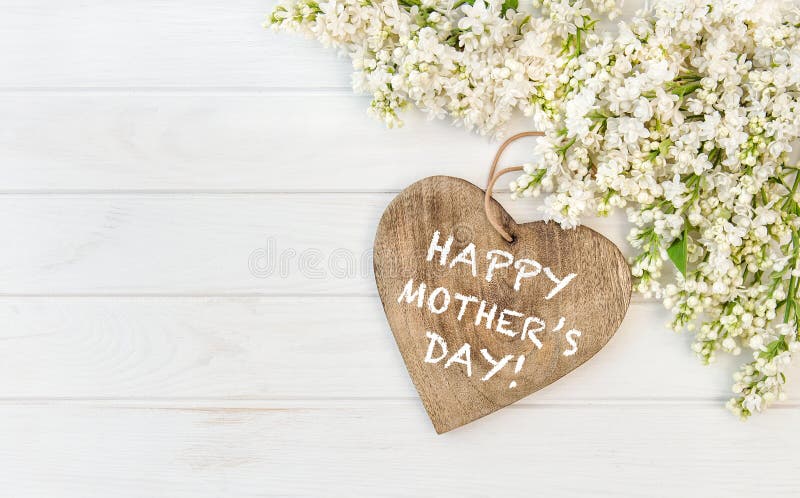 White lilac flowers wooden heart Mothers Day