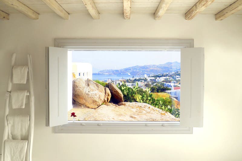 White magic window offering a beautiful view of the island of Mykonos Greece in the Cyclades in the heart of the Aegean Sea