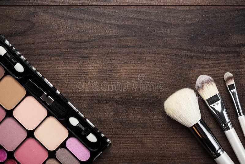 White make-up brushes on wooden background