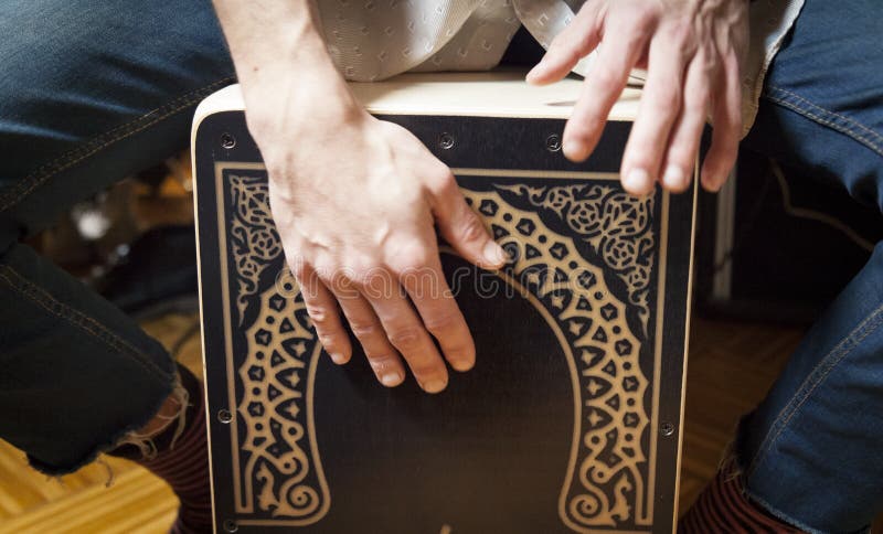 Hands playing percussion with a Flamenco box stock images