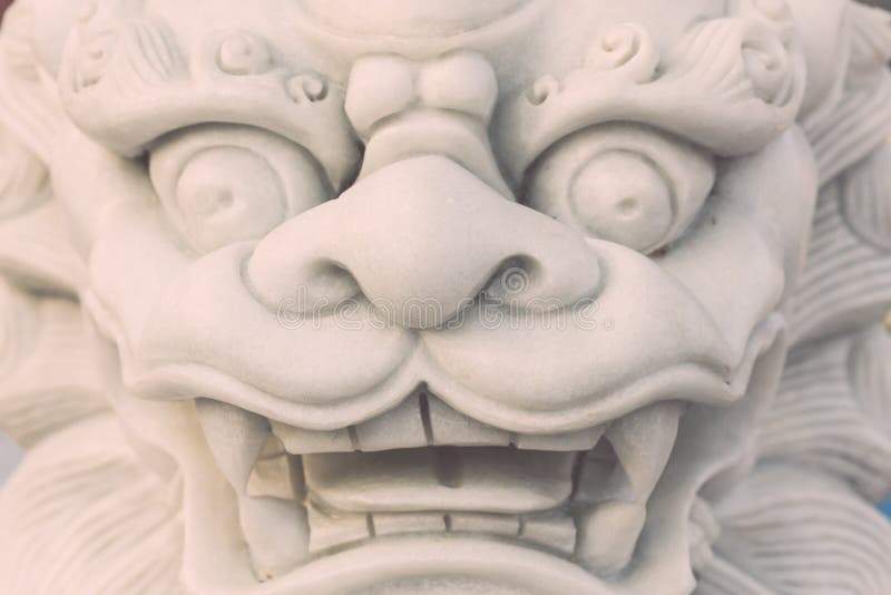 White marble lion statue stand in Chinese temple, Thailand