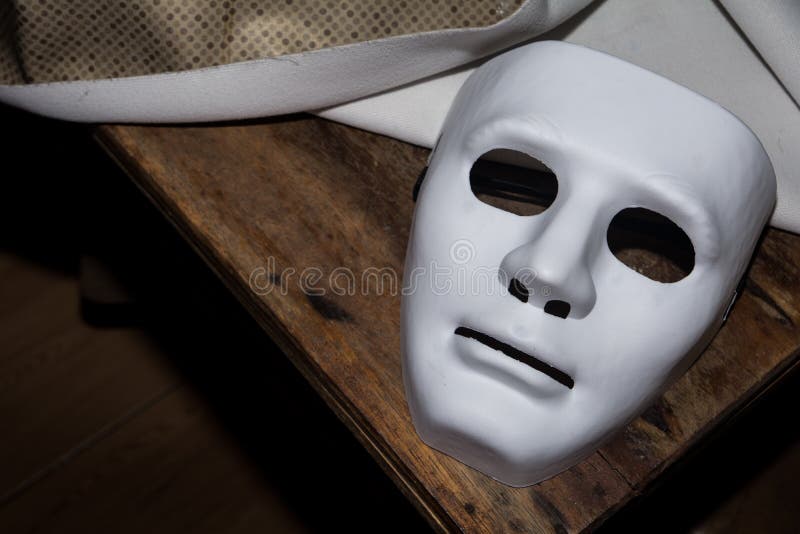 The man in white mask threatens, killer concept, horror theme , Halloween  concepts Stock Photo