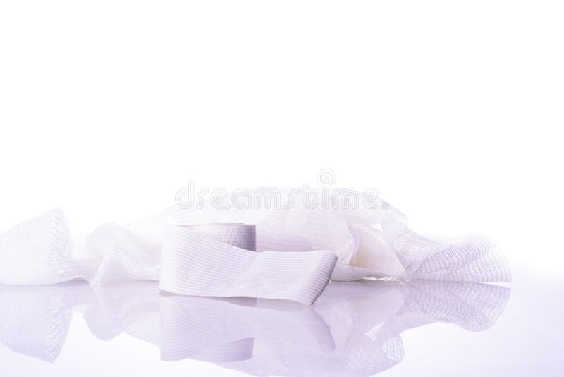 White medical cotton gauze bandage on white stock photo White medical cotton gauze bandage on white stock photo
