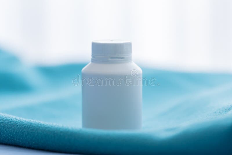 A White Medicine Bottle on the Green Bed Sheet Stock Photo Image of