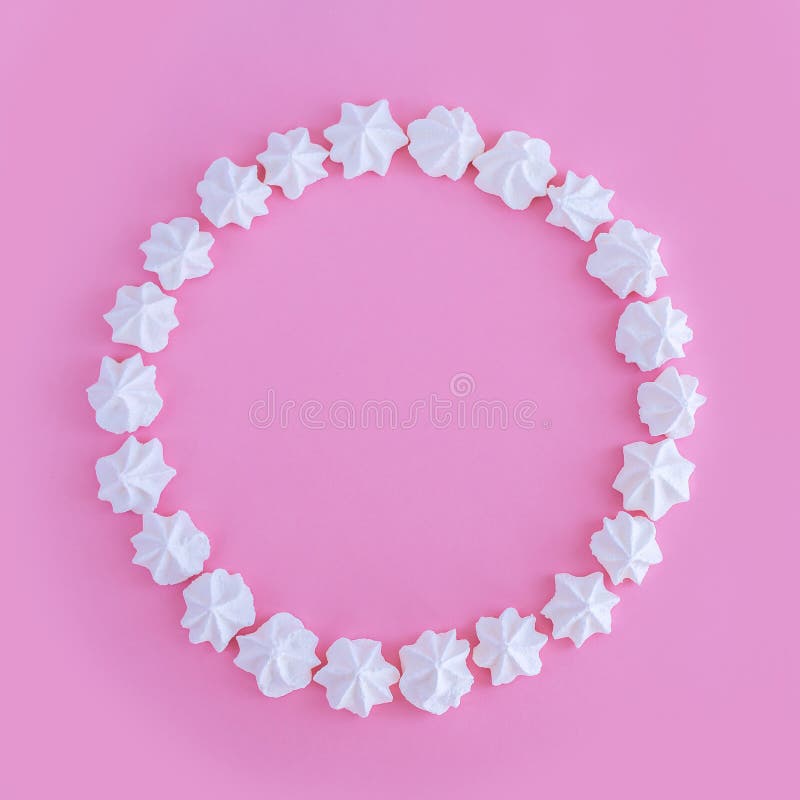 White meringues round frame on pink background royalty free illustration White meringues round frame on pink background royalty free illustration
