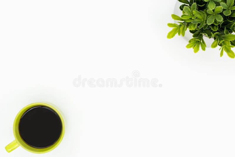 White minimal desk table with green coffee cup and tree pot. Top view with copy space, flat lay royalty free stock images