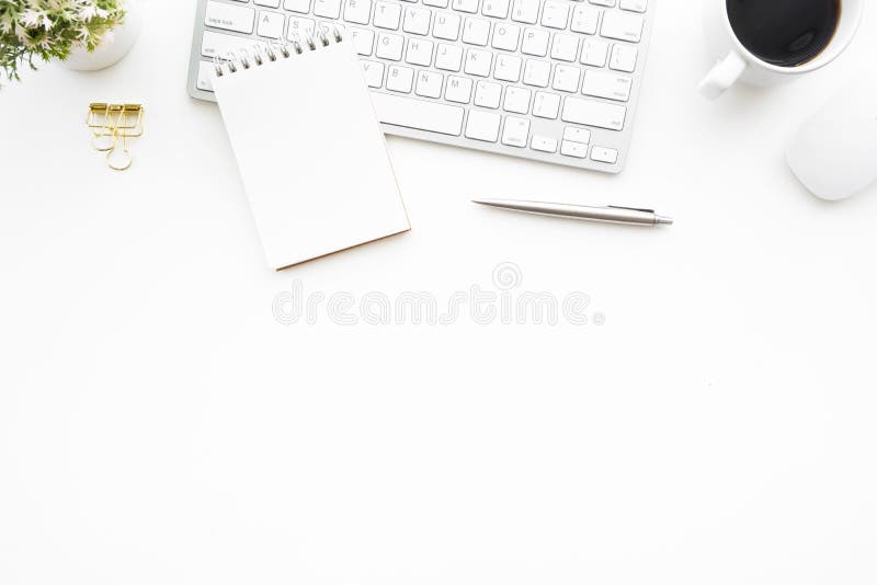 White minimal office desk table with computer keyboard, mouse and supplies. Top view with copy space, flat lay stock image