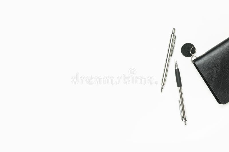 White minimal office desk table with notebook and pens. Top view with copy space, flat lay stock photos