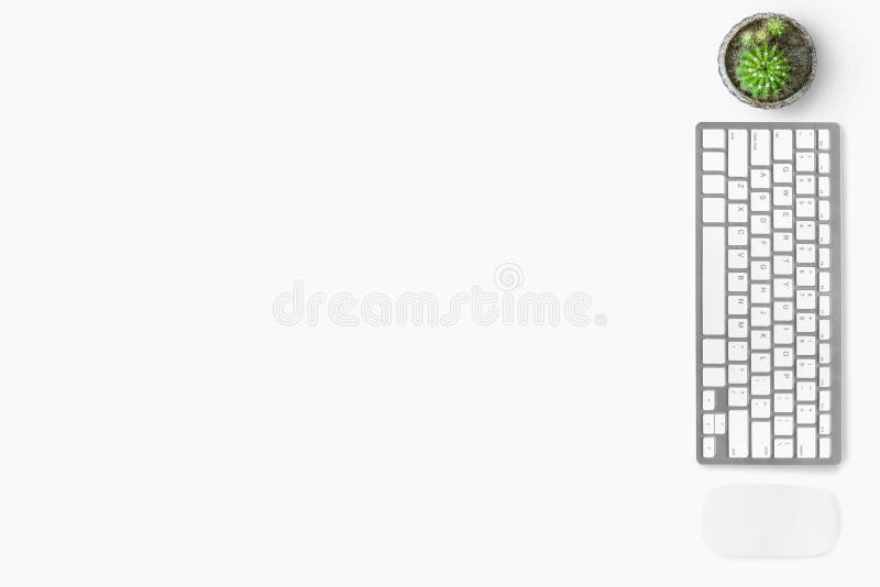 White minimal office desk table with wireless computer mouse and keyboard. Top view with copy space, flat lay royalty free stock images