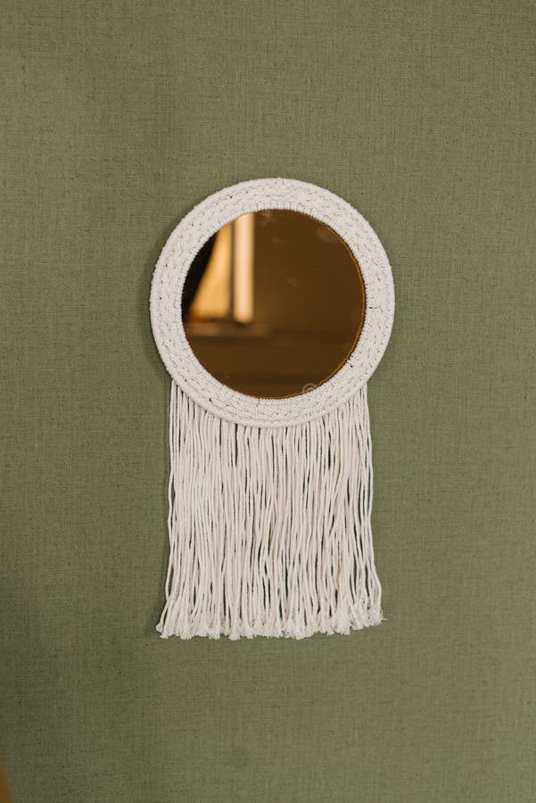 White Mirror with a Fringe of White String Hanging from it Stock Image