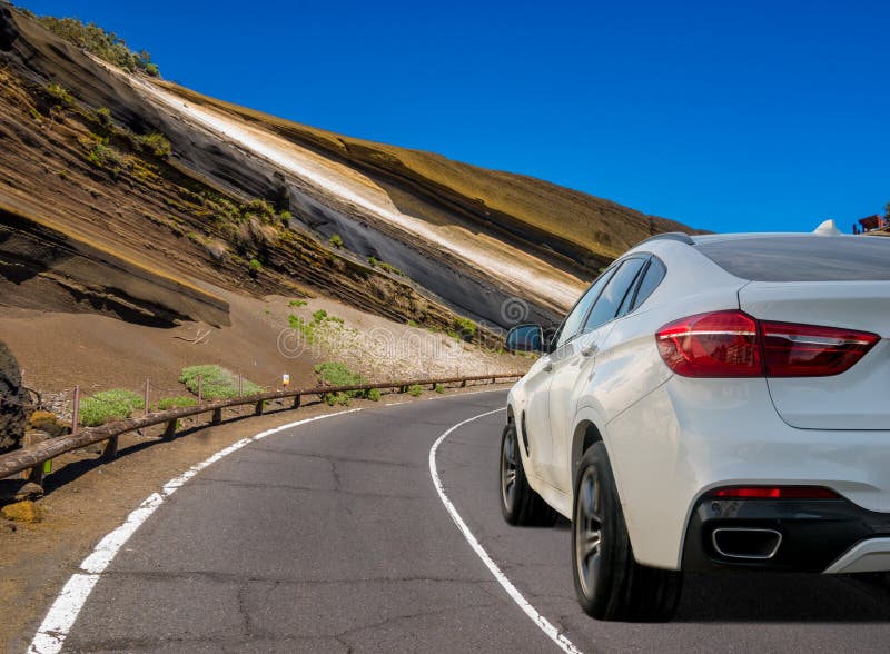 White, modern SUV on the mountain road