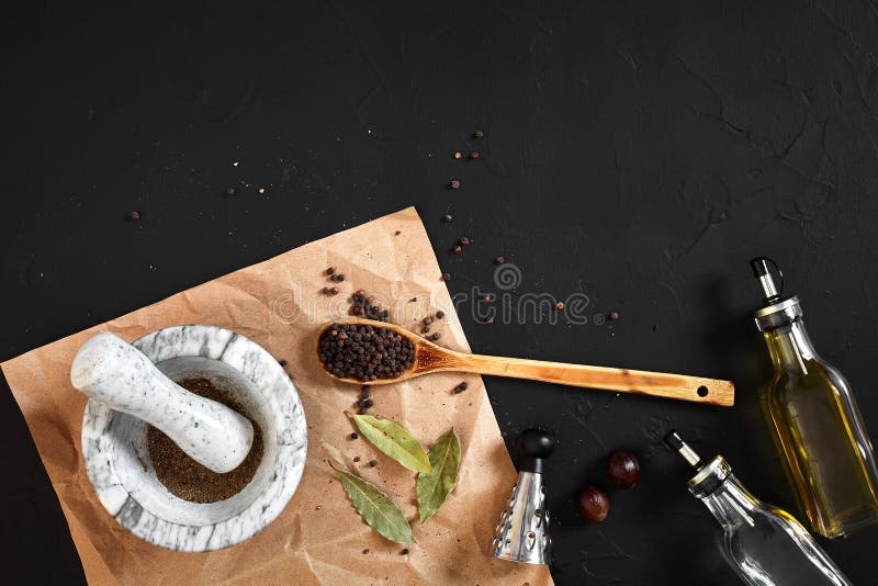 White mortar and pestle with dried peppers in flat lay on black background royalty free stock photo White mortar and pestle with dried peppers in flat lay on black background royalty free stock photo