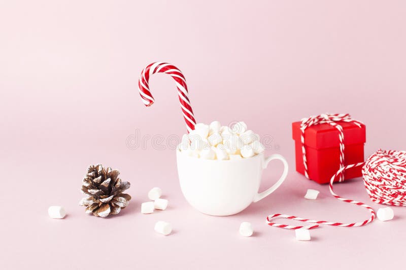 White mug with marshmallows Candy Cane, red gift box, pine cone, decorative lace on pink background Flat Lay Winter traditional stock photos White mug with marshmallows Candy Cane, red gift box, pine cone, decorative lace on pink background Flat Lay Winter traditional stock photos