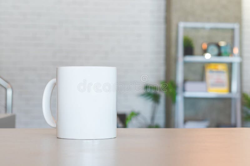 White mug on table and modern room background. Blank drink cup for your design. Can put text, image, and logo royalty free stock photos