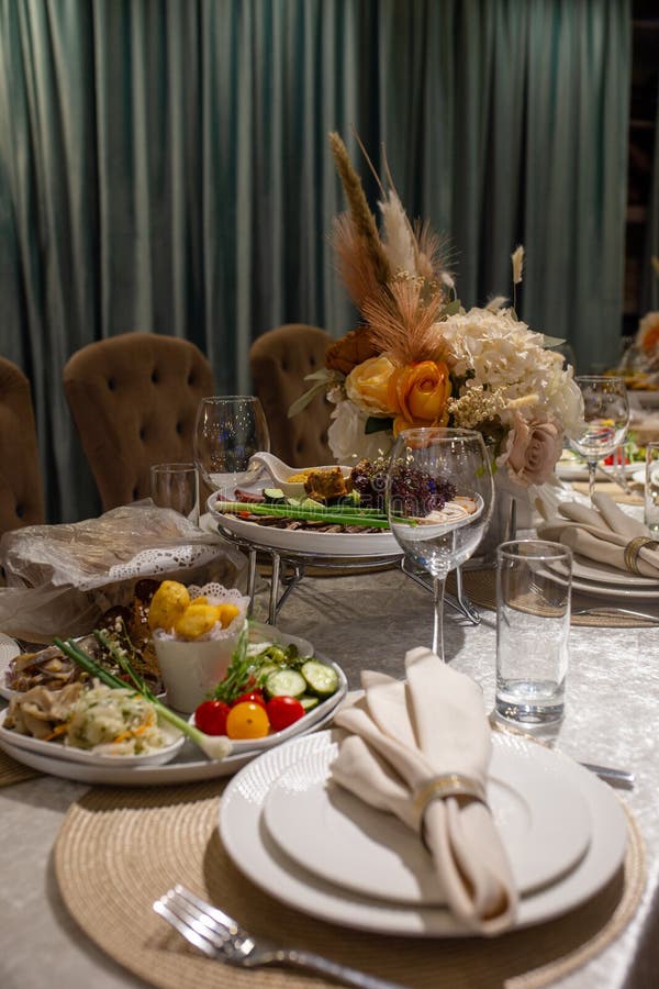 White Napkins, Beautifully Folded on Plates in a Restaurant. Restaurant